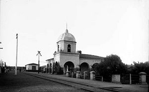 (PD) Photo: William Henry JacksonOne of the earliest examples of "Mission Revival Style" architecture, the Atchison, Topeka and Santa Fe Railway depot in San Juan Capistrano (with its 40-foot [12-meter] high dome and bell) was considered to be one of the railroad's finest when it was completed on October 8, 1894; it officially entered service on October 27 of that year.[7] The San Juan Capistrano station has remained in use and today is served by Amtrak, the national railroad passenger system, and Metrolink, a commuter railroad.