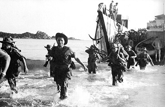 French Marines wading ashore off the coast of Annam (Central Vietnam) in July 1950, using US-supplied ships, weapons, equipment. Quote by Bernard Fall in gallery title.[10]:702